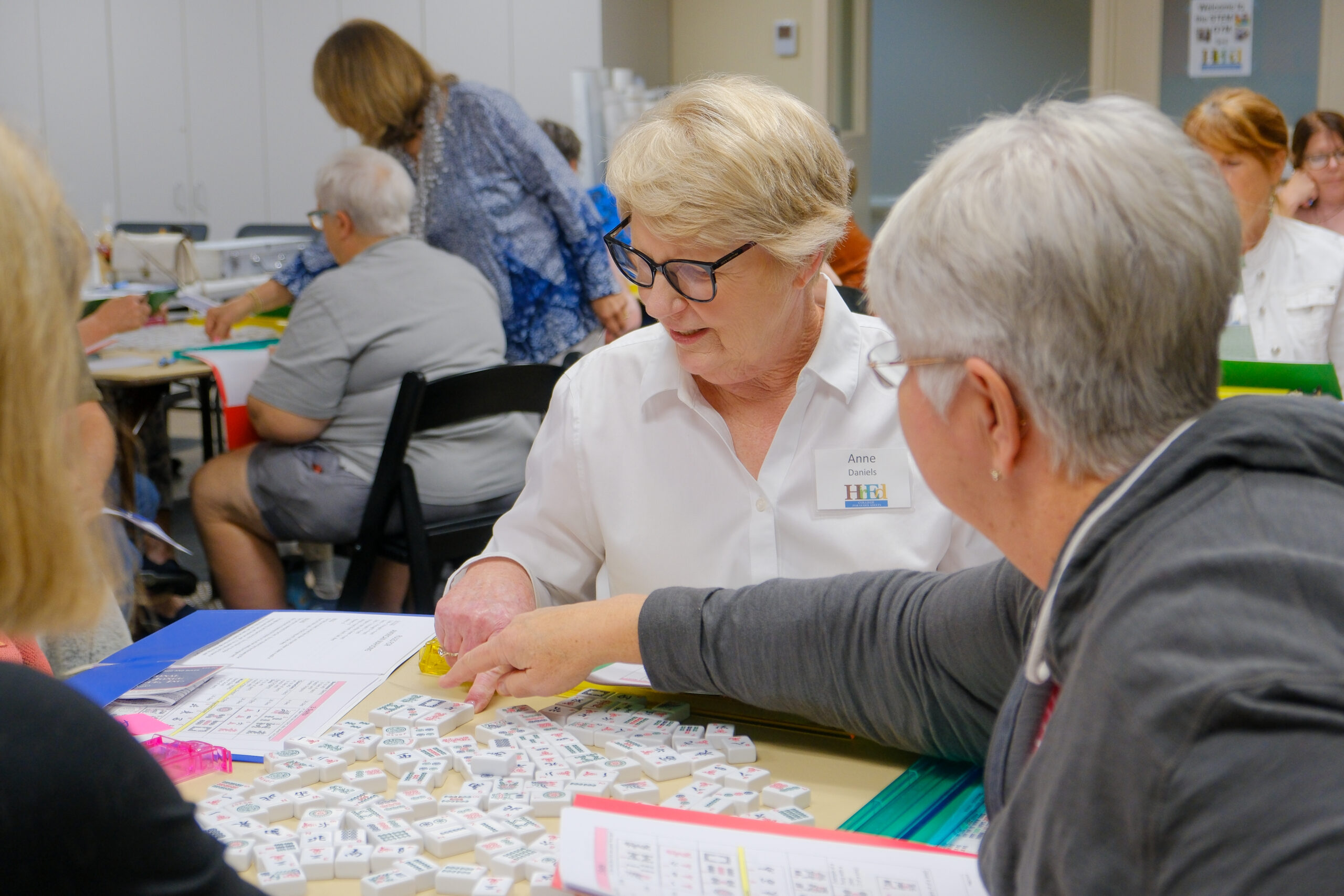 A lady raising her hand during a College for Older Adults course at the Southwest Virginia Higher Education Center.