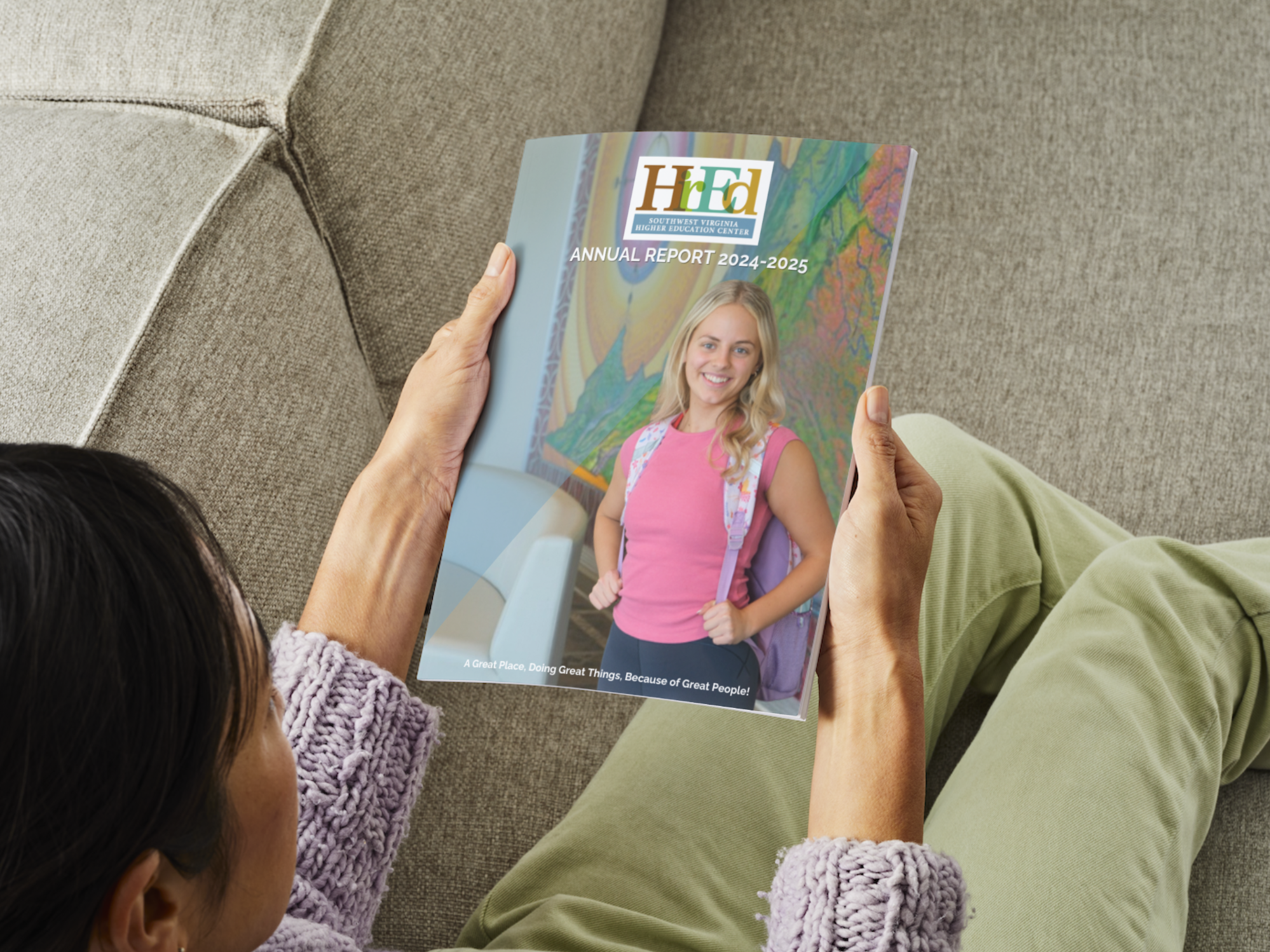 Individuals sitting in a large room listening to a panel of five men during a conference event.