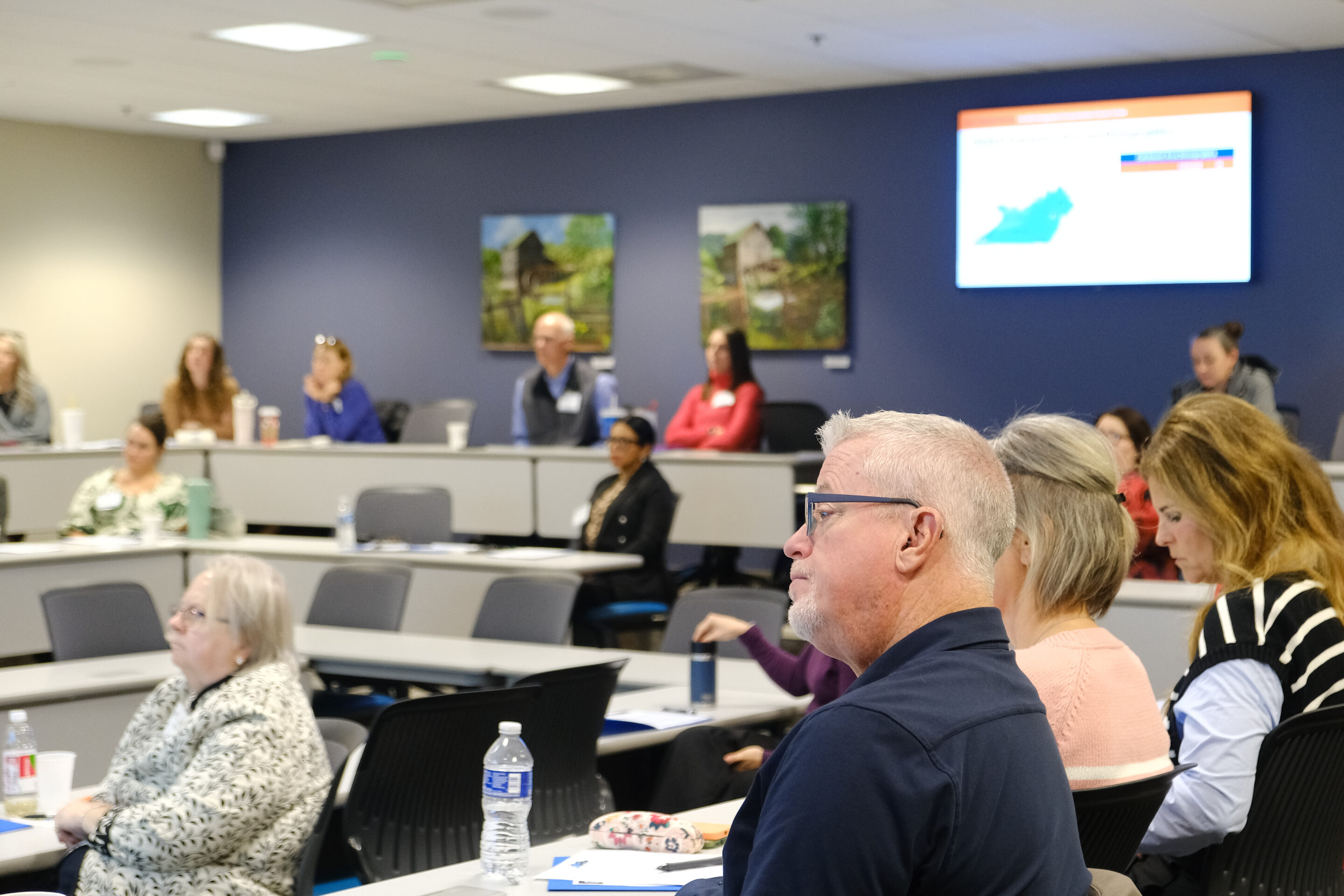 Room 235 offers a long table for conference meetings that can accommodate 14 attendees.