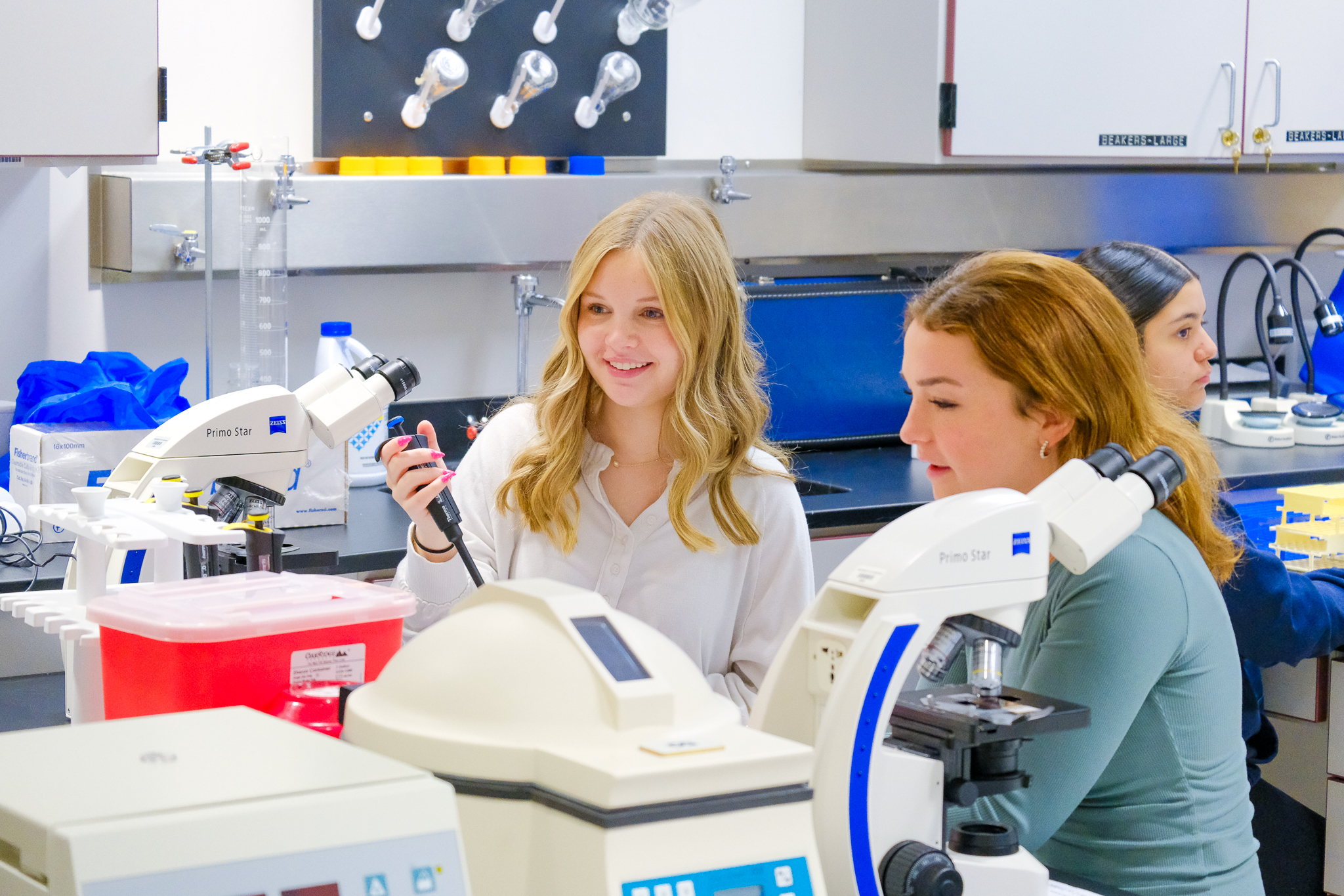 A high school student participating in a hands-on skill at HEALS lab school.